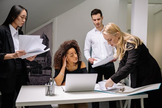 A vibrant office space with team members working and collaborating, showing an active business environment.