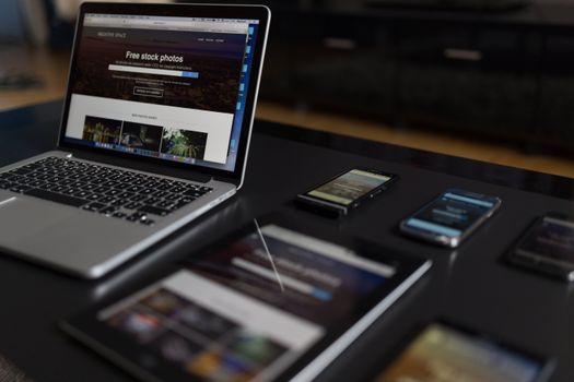 Responsive website design displayed on multiple devices including laptop, tablet, and phone