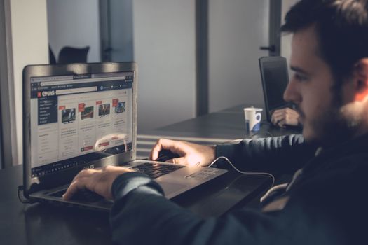 Business person using eWebGen AI website builder on a laptop